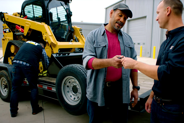 Landscaper Getting the Keys to a New Cat Skid Steer