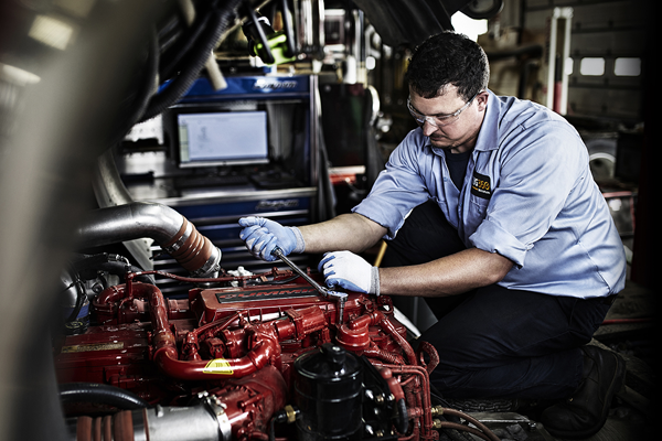 Yancey Technician Working On Truck Engine