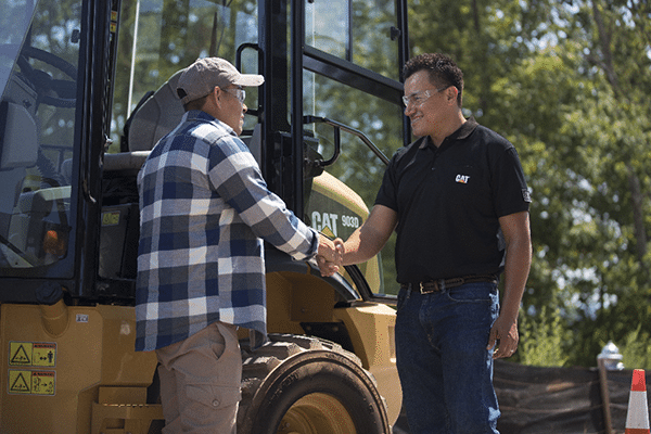 Yancey Technician Shaking Hands with Cat Equipment Owner