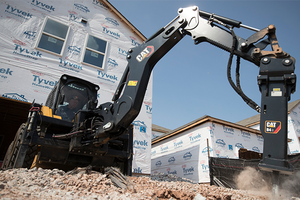 Cat Smart backhoe attachment working on building a house